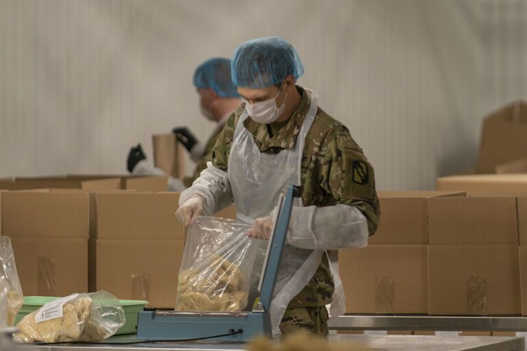 137th Infantry Regiment assist in packaging food items at the Harvesters Food Bank in Kansas City