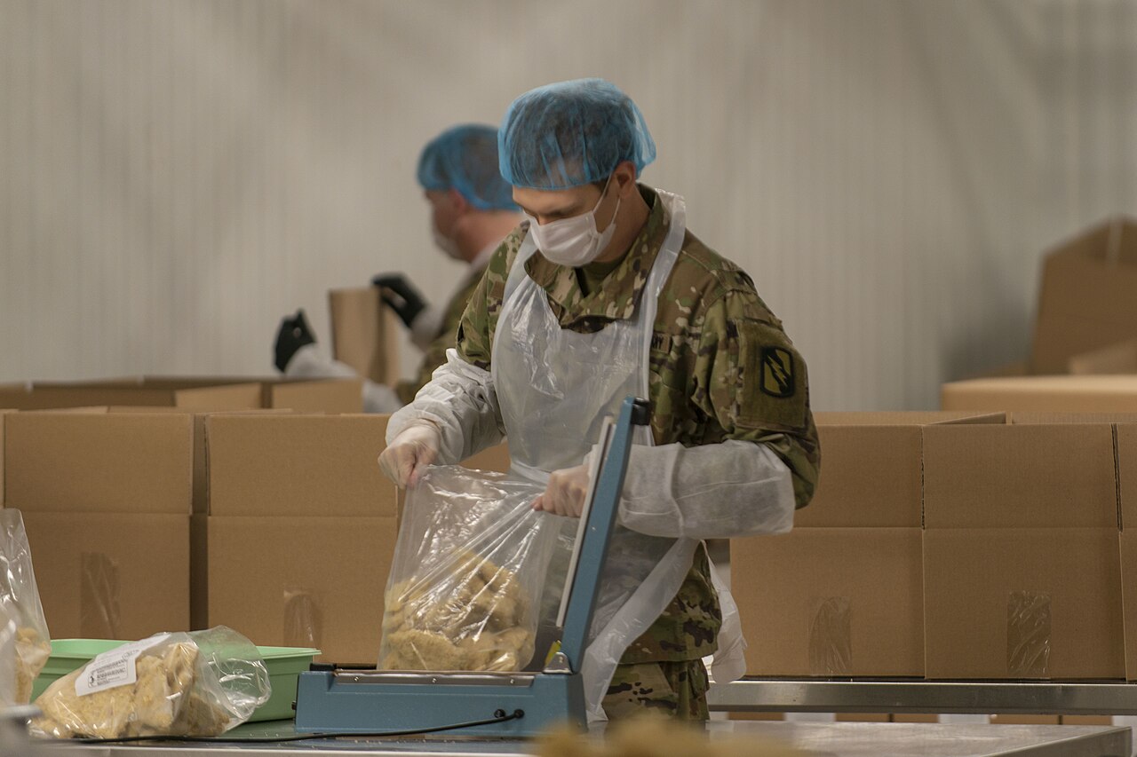 137th Infantry Regiment assist in packaging food items at the Harvesters Food Bank in Kansas City