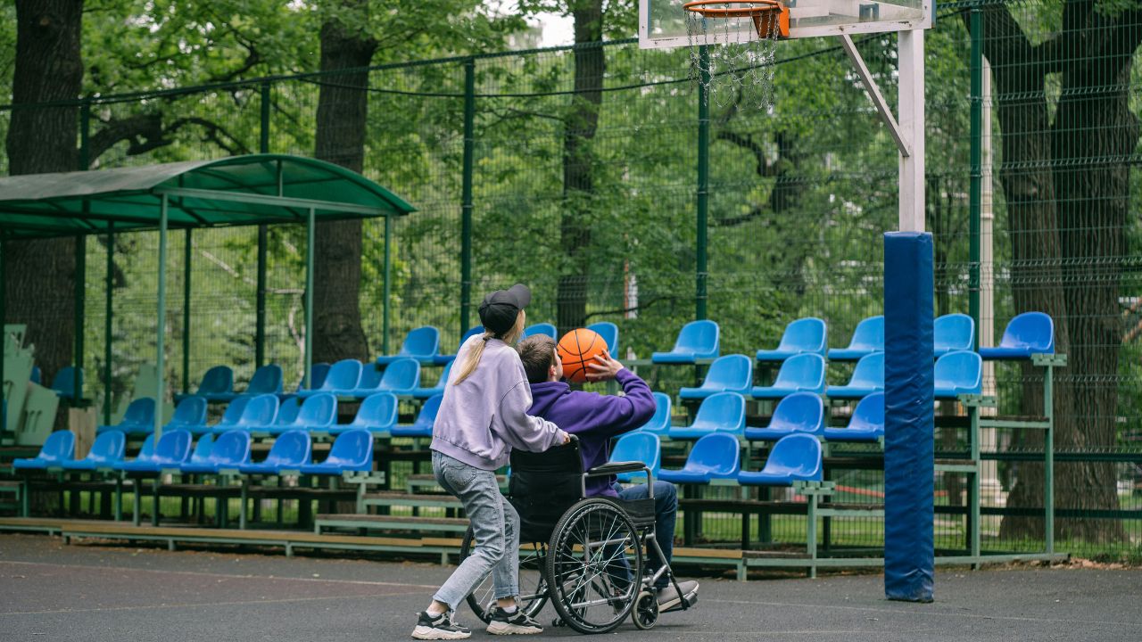 A Man in a Wheelchair Shooting a Ball
