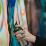 person holding a spray paint